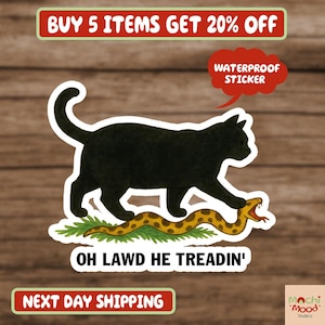 May include: A black cat sticker with the text "OH LAWD HE TREADIN'" stepping on a yellow and brown snake. The sticker also has the text "WATERPROOF STICKER".