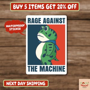 May include: A waterproof sticker featuring a green frog with black spots, wearing a blue scarf, and the text "RAGE AGAINST THE MACHINE." The background is split red and blue.