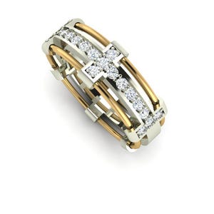 Peut inclure: Une bague bicolore avec un motif de croix. La bague pr&eacute;sente un anneau dor&eacute; et un anneau argent&eacute;, avec une rang&eacute;e de pierres pr&eacute;cieuses claires. La croix est form&eacute;e par l'intersection des anneaux dor&eacute;s et argent&eacute;s.