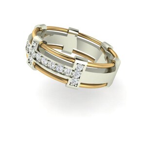 Peut inclure: Une bague bicolore avec une bande dor&eacute;e et un centre argent&eacute;. La bague pr&eacute;sente une rang&eacute;e de petits pierres pr&eacute;cieuses claires et des accents dor&eacute;s. Le design est moderne et g&eacute;om&eacute;trique, avec des lignes &eacute;pur&eacute;es et des mat&eacute;riaux contrast&eacute;s.
