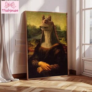 May include: A framed art print featuring a humorous mashup of the Mona Lisa and Jar Jar Binks from Star Wars. The artwork is set against a landscape background with a gold frame. The print is leaning against a wall.