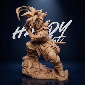 May include: A tan-colored figurine of a warrior in a dynamic pose, holding a sword. The figure is standing on a rocky base, with detailed sculpting of the hair and clothing. The background is a dark blue gradient with the text "HANDY NIGHT" in white.