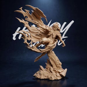 May include: A detailed, tan-colored figurine of a character in a dynamic pose, holding a gun and wearing a flowing cape. The figure is mounted on a rocky base, with the words "Holy Hero" in white script in the background.