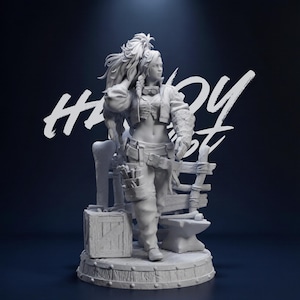 May include: A detailed, grayscale figurine of a woman in a work outfit, standing next to a wooden crate and anvil. The figure is wearing a cropped jacket, pants, and tool belt. The word "HANDY" is written in white script across the background.