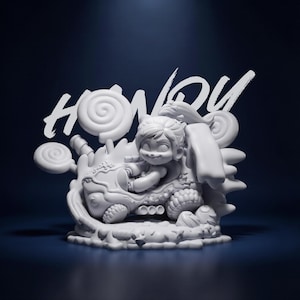 May include: A white figurine of a smiling child riding a dragon-like creature, with candy-shaped accents. The word "HONY" is written in a stylized font above the figurine. The figurine is set against a dark blue background.