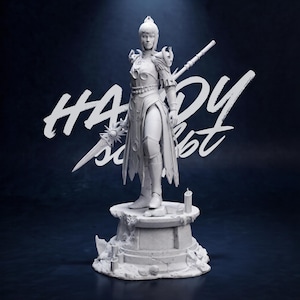 May include: A white figurine of a warrior woman, holding a sword and a staff, stands on a stone pedestal. The figurine is detailed with armor and a flowing gown. The background is dark blue with the text "HANDY set" in white.