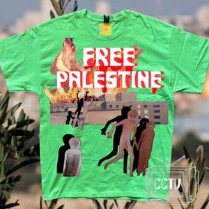 May include: A bright green t-shirt with the words "FREE PALESTINE" in white and red. The shirt features a graphic of a burning building and stylized figures. A small "CCTV" logo is visible.