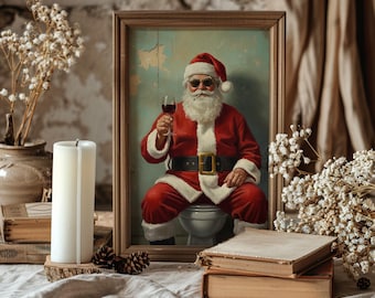 May include: A framed print depicts Santa Claus in a red suit, sunglasses, and a white beard, holding a glass of red wine. The image is set against a distressed blue background. The frame is a light brown color. The scene is surrounded by decorative elements.