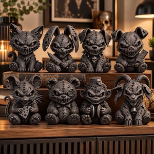 May include: A collection of eight dark gray, stitched-texture figurines arranged in two rows. The figures include a cat, rabbit with a knife, dog with a skull collar, pig with a cleaver, mouse with cheese, bear, monkey with cymbals, and a goat.