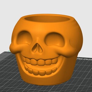 May include: An orange skull-shaped planter with a wide, smiling mouth and eye sockets. The planter is made of a solid material and has a smooth surface. The skull design is a popular theme for Halloween and gothic decor.