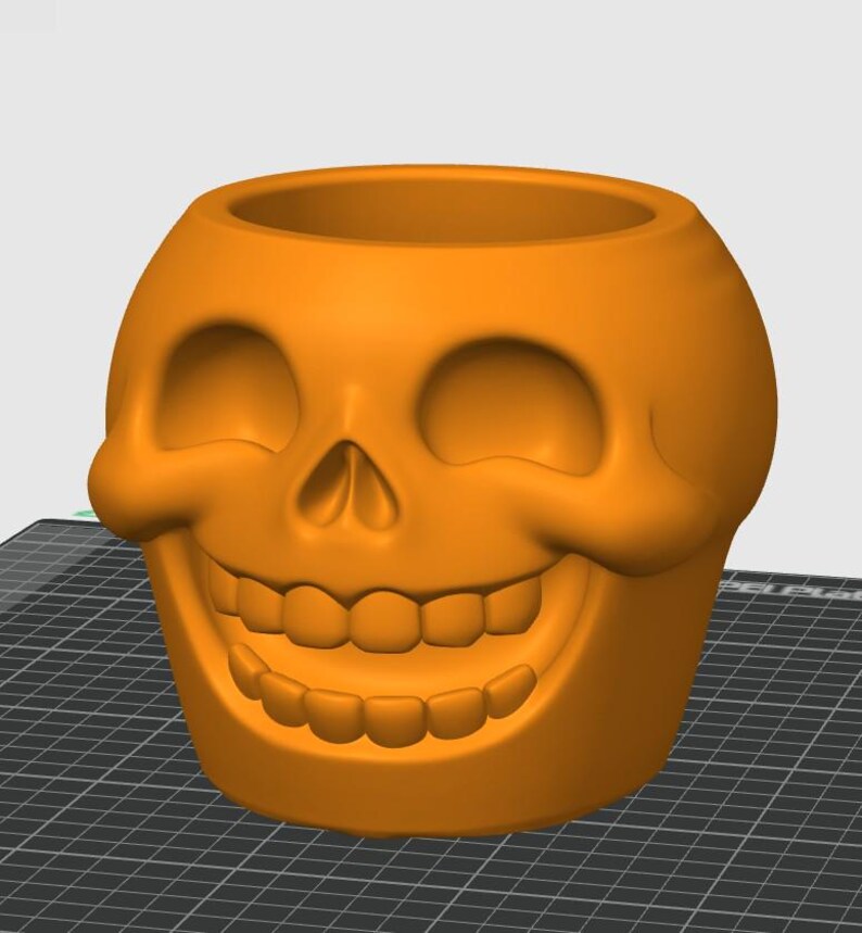 May include: An orange skull-shaped planter with a wide, smiling mouth and eye sockets. The planter is made of a solid material and has a smooth surface. The skull design is a popular theme for Halloween and gothic decor.