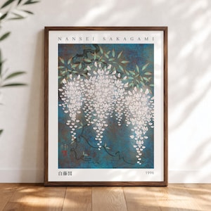 May include: A framed art print titled NANSEI SAKAGAMI 1996 featuring white wisteria flowers hanging from dark branches against a textured blue background. The print includes the text NANSEI SAKAGAMI at the top and the Japanese text 白藤図 at the bottom.