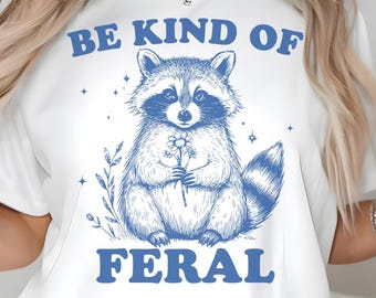 Be Kind of Feral PNG SVG, Cute Raccoon Holding Flower, Funny Soft Feral Quote Shirt Design, Funny Raccoon Png