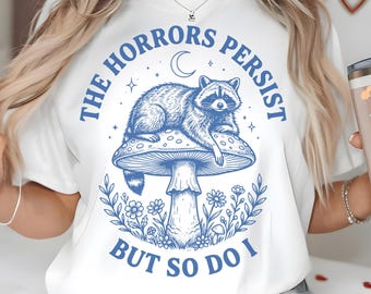 The Horrors Persist But So Do I PNG SVG, Raccoon on Mushroom Toadstool, Funny Goth Cottagecore Trash Panda Quote Shirt, Woodland Raccoon Png