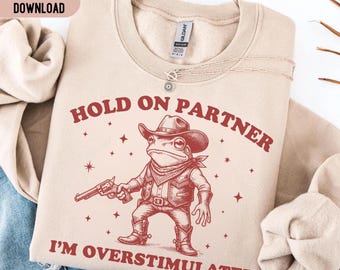 Hold On Partner I'm Overstimulated PNG SVG, Funny Cowboy Frog Shirt, Western Frog Meme Tee, Sarcastic Anxiety Humor Design