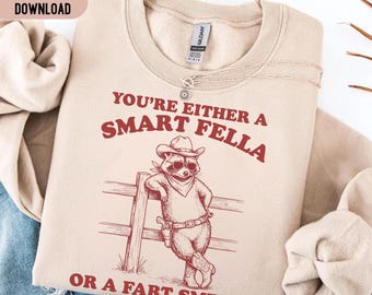 You're Either A Smart Fella Or A Fart Smella PNG SVG, Funny Cowboy Raccoon Shirt, Western Trash Panda Meme Tee