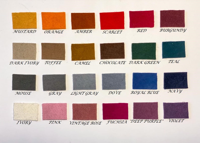 May include: A color chart featuring small, rectangular felt swatches in a variety of colors. The swatches are labeled with color names such as "Mustard," "Orange," "Amber," "Scarlet," "Red," and "Burgundy."