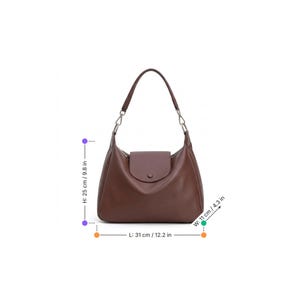 May include: A brown leather shoulder bag with a flap closure and a single handle. The bag is 31 cm long, 25 cm high, and 11 cm wide. The handle is attached to the bag with silver-colored chain links.