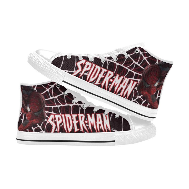 May include: High-top canvas sneakers featuring a Spider-Man design. The shoes have a white rubber sole and laces. The sides display a red and black web pattern with the words "SPIDER-MAN" and an image of Spider-Man.