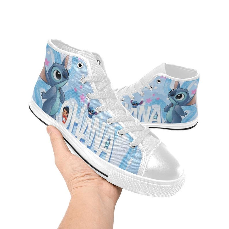 Puede incluir: Zapatillas altas de lona con fondo azul claro y la palabra "OHANA" en blanco. Las zapatillas presentan un dise&ntilde;o de personaje de dibujos animados, puntera blanca y cordones blancos.