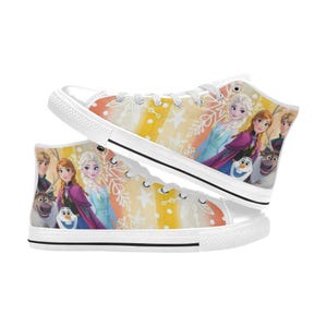 May include: High-top canvas sneakers featuring characters from the animated film. The shoes have a white rubber sole and laces. The design includes images of Elsa, Anna, Olaf, Kristoff, and Sven on a colorful background with snowflakes.