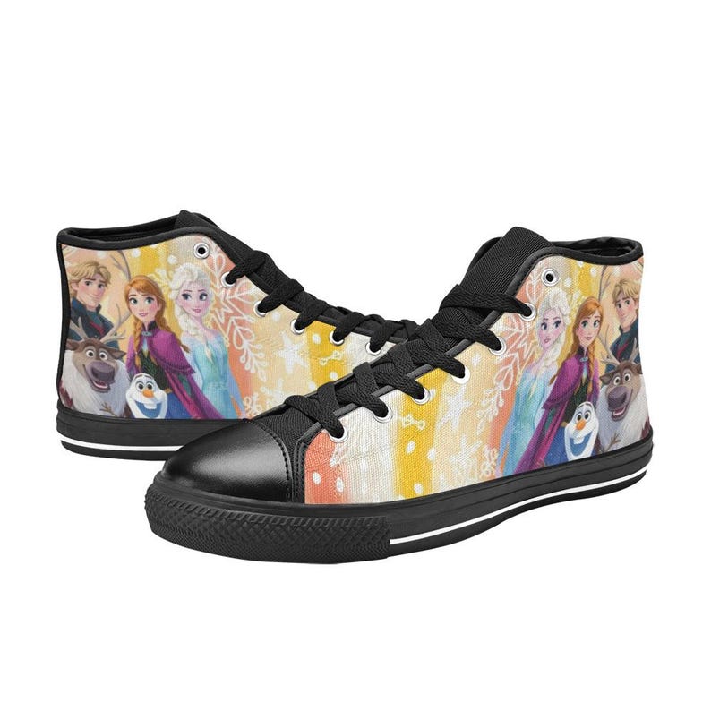 May include: High-top sneakers featuring a colorful design with characters from the animated movie "Frozen". The shoes have a black toe cap, black laces, and a black sole. The background has a yellow, orange, and white striped pattern.