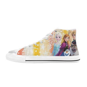 May include: High-top canvas sneakers featuring a colorful design with characters from the animated movie Frozen. The shoes have a white rubber sole, white laces, and a vibrant graphic on the side.