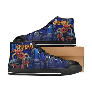 Op de afbeelding: Hoge canvas sneakers met een Spider-Man ontwerp. De blauwe achtergrond toont een stadsgezicht met de superheld. De schoenen hebben zwarte zolen, veters en neus, met het Spider-Man logo aan de zijkant.