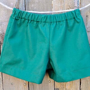 May include: A pair of green shorts with an elastic waistband.