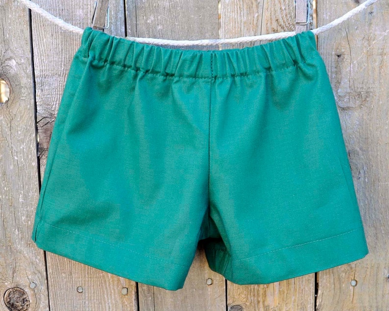 May include: A pair of green shorts with an elastic waistband.