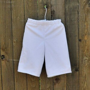May include: White cotton shorts with an elastic waistband.