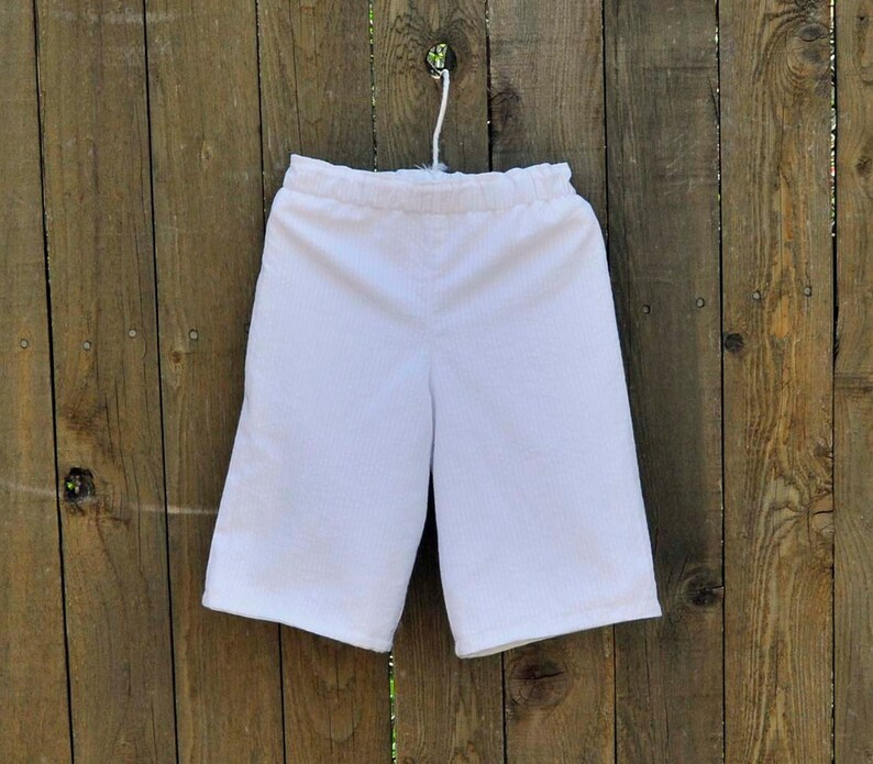May include: White cotton shorts with an elastic waistband.