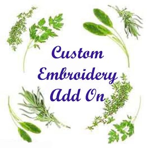 May include: Custom Embroidery Add On, a text phrase in purple lettering surrounded by a circle of green leafy sprigs.