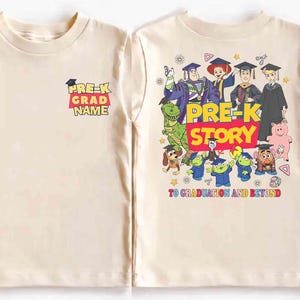 May include: Two cream-colored t-shirts. One has "Pre-K Grad Name" text. The other has a colorful graphic of Toy Story characters with "Pre-K Story" text and "To Graduation and Beyond".