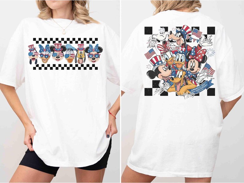 May include: White t-shirt featuring a graphic of Disney characters in patriotic attire. The front displays character faces with sunglasses, while the back showcases a group of characters with flags and fireworks. A black and white checkered pattern frames the designs.