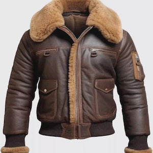 May include: A brown leather bomber jacket with a shearling collar and lining. The jacket features multiple pockets, a zip-up front, and ribbed cuffs and hem. The jacket has a classic aviator style.