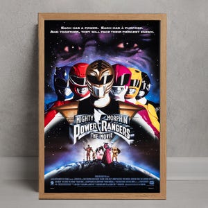 May include: A framed poster for "Mighty Morphin Power Rangers: The Movie." The image shows six Power Rangers in their helmets, with the text "Each has a power. Each has a purpose. And together, they will face their fiercest enemy."