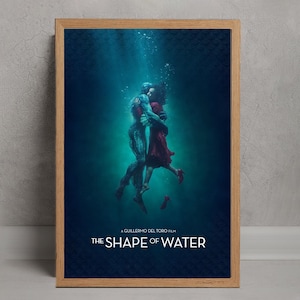 May include: Framed poster for the film "The Shape of Water". The image shows a couple embracing underwater, with a dark blue background. The film's title is in white. The woman wears a red dress, and the man has a blue-green skin tone.