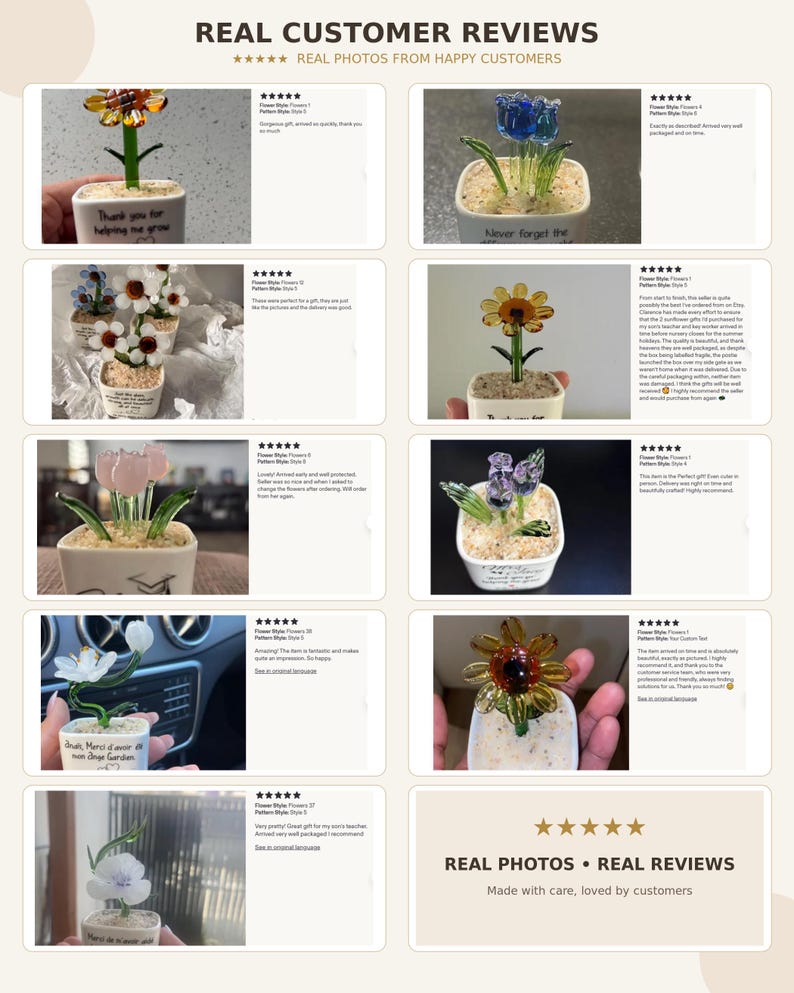 May include: A collection of glass flower ornaments in small square white pots filled with decorative pebbles. Each glass flower features distinct colors and shapes, with some pots displaying printed text messages in various languages.