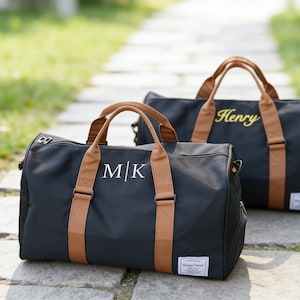 May include: A white ceramic mug with a black handle and the text "But First, Coffee" in a bold, black font. The mug is set against a blurred background, suggesting a cozy setting. The mug appears to be approximately 4 inches tall.