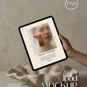 May include: A black iPad mockup held by a person, displaying a blurred image of a face. The text "Device Mockup" and "Organic Modern iPad Mockup" are visible. A decorative, textured bowl is in the foreground.