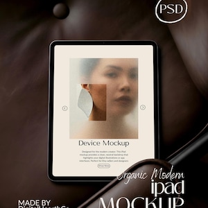 May include: An iPad mockup with a neutral backdrop, showcasing a digital illustration. The screen displays a blurred image of a person wearing an earring. Text on the screen reads "Device Mockup" and "Organic Modern iPad Mockup". The image is set against a dark brown background.