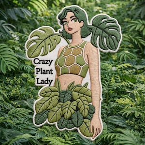 Puede incluir: Parche bordado que representa a una mujer con cabello verde y un atuendo con temática de plantas. El parche incluye el texto "Crazy Plant Lady" y está rodeado de hojas verdes. El diseño incorpora tonos de verde, marrón y beige.