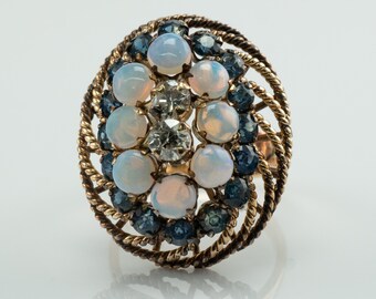 May include: A gold ring with a cluster of white opals and blue sapphires set in a twisted rope design.