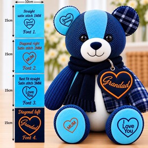 May include: A blue teddy bear with a dark blue scarf and a heart-shaped tag reading Grandad. The bear features a herringbone pattern, plaid ears, and light blue paw pads with text reading MUM and I Love You. A chart shows 10cm by 15cm stitch options.