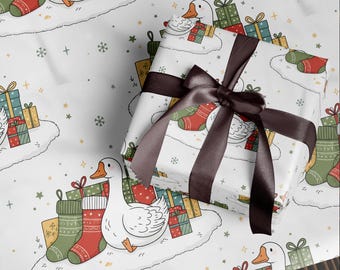 May include: White wrapping paper with a repeating pattern of cartoon geese, Christmas stockings, and wrapped gifts. A wrapped gift with a brown ribbon sits on top of the paper. The overall theme is Christmas.