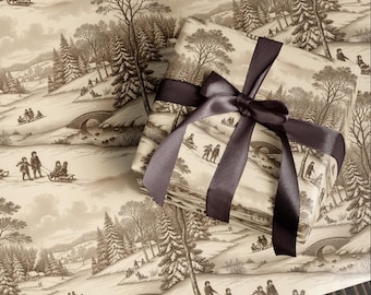 May include: Gift wrapped in winter scene paper with a dark brown satin ribbon. The paper features a sepia-toned illustration of people sledding down snowy hills, trees, and bridges. The ribbon is tied in a large bow.