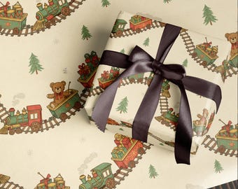 May include: A wrapped gift with a dark brown satin ribbon bow sits on wrapping paper. The wrapping paper features a repeating pattern of green and red toy trains, teddy bears, gifts, and Christmas trees on a cream background.
