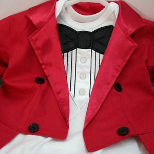 May include: A red tuxedo jacket with a white shirt and a black bow tie. The jacket has a satin lapel and four black buttons.