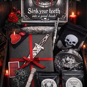 May include: A dark, gothic-themed gift box with various items. It features a wrapped package with a decorative knife, skull socks, a Freddy Krueger coaster, and bags labelled "Clown Nose" and "Mummy Dust". The box is decorated with roses and candles.